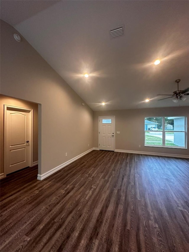 unfurnished living room with visible vents, dark wood finished floors, and baseboards