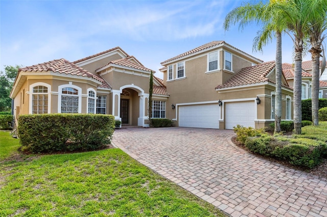 mediterranean / spanish-style house with a front yard