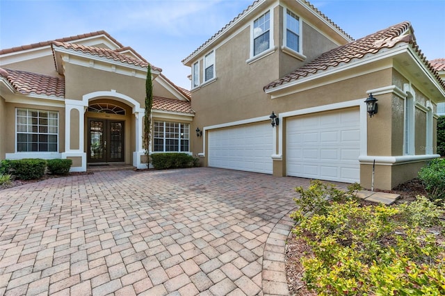 mediterranean / spanish-style home with french doors