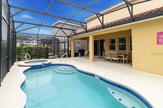 view of pool with an in ground hot tub, area for grilling, a lanai, and a patio area