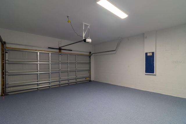 garage featuring a garage door opener and electric panel