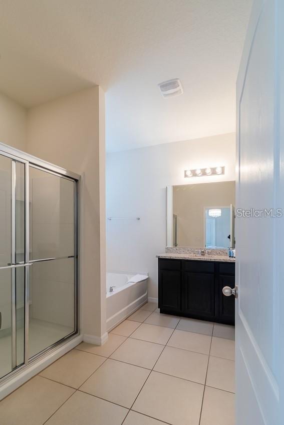 bathroom with shower with separate bathtub, tile patterned floors, and vanity