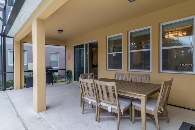 6047 Broad Oak Dr, Davenport, FL 33837 - view of patio featuring glass enclosure and outdoor dining area