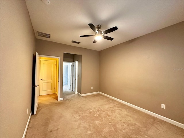 empty room featuring carpet floors and ceiling fan