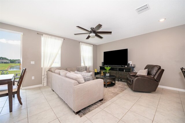 tiled living room with ceiling fan