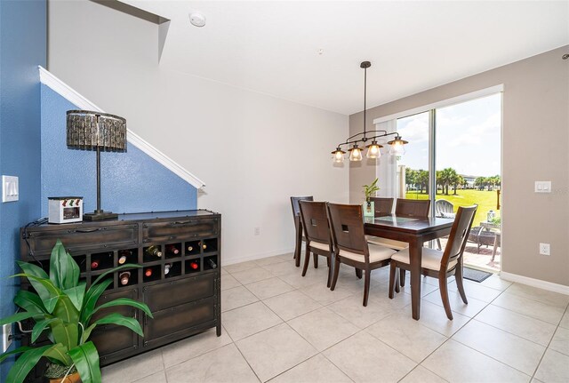 dining space with a notable chandelier and light tile patterned floors