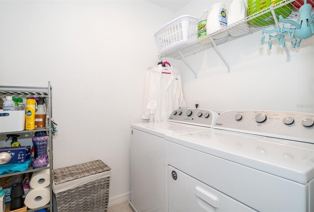 clothes washing area with separate washer and dryer