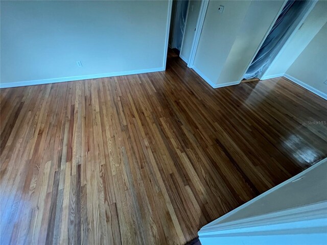 unfurnished room featuring hardwood / wood-style flooring