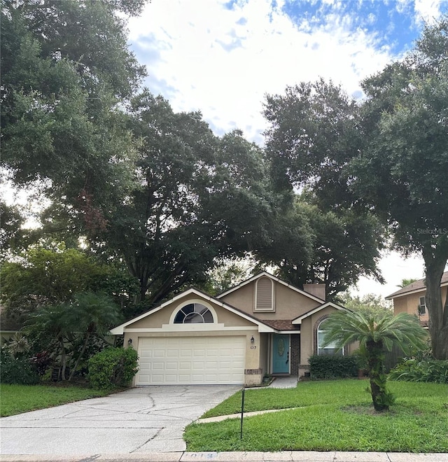 view of front of property featuring a garage and a front lawn