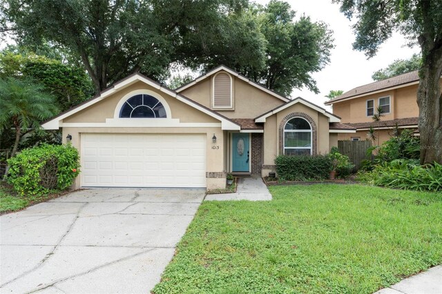 view of front of property with a garage and a front lawn