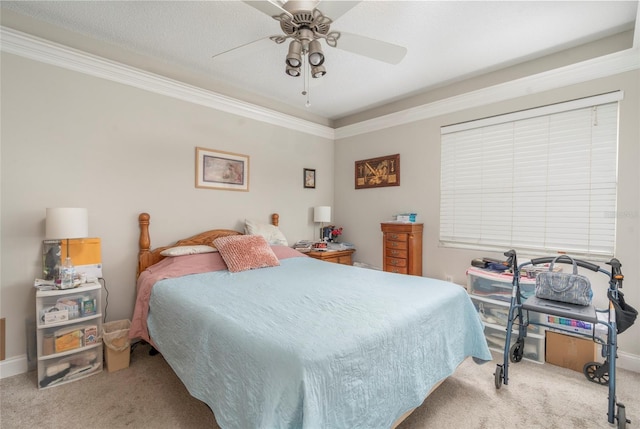 carpeted bedroom featuring baseboards, a ceiling fan, and crown molding