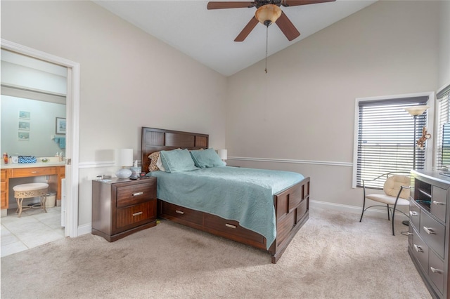 bedroom with light carpet, baseboards, connected bathroom, lofted ceiling, and ceiling fan