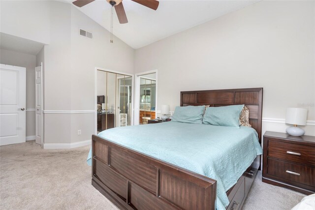 bedroom with high vaulted ceiling, light colored carpet, ceiling fan, and a closet