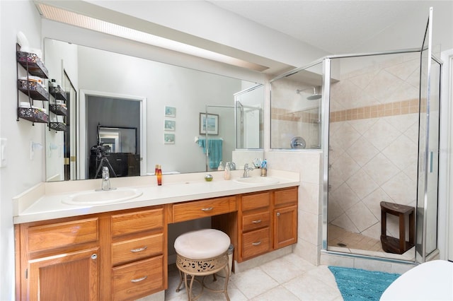 bathroom with tile patterned flooring, vanity, a textured ceiling, and a shower with shower door