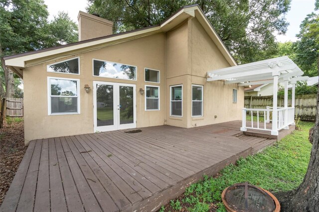 back of house featuring a pergola, a deck, french doors, and an outdoor fire pit