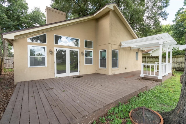 back of property featuring an outdoor fire pit, a pergola, french doors, and stucco siding