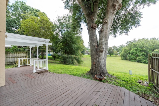 deck featuring a lawn, fence, and a pergola