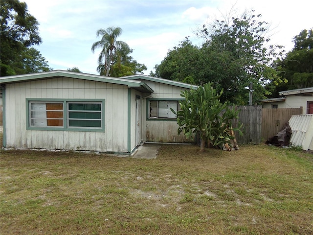 view of side of property with a lawn