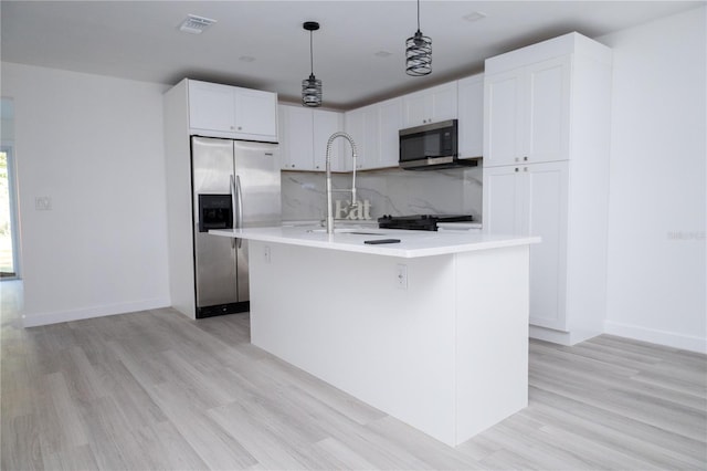 kitchen featuring a kitchen island with sink, light hardwood / wood-style flooring, appliances with stainless steel finishes, and white cabinets