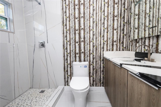 bathroom featuring vanity, tiled shower, toilet, and tile patterned flooring