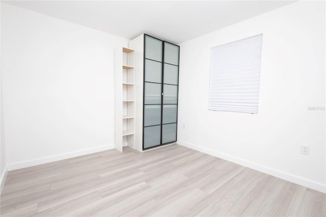 unfurnished room with light wood-type flooring