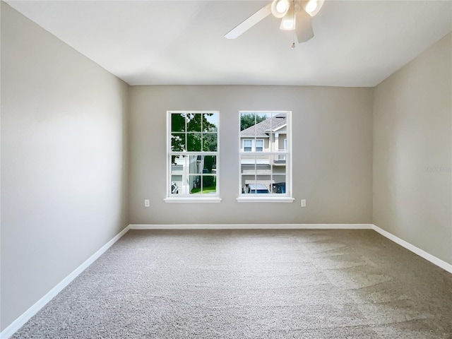 unfurnished room featuring ceiling fan and carpet flooring