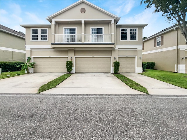 view of front of home with a garage and a balcony