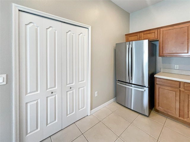 kitchen with stainless steel refrigerator and light tile patterned floors