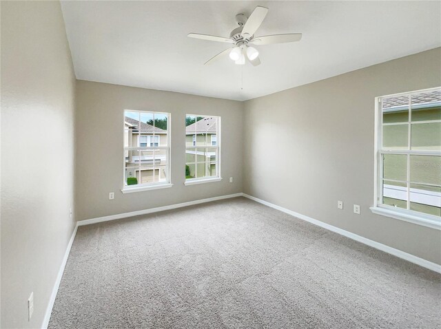 empty room featuring carpet flooring and ceiling fan