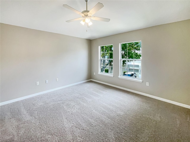 carpeted spare room with ceiling fan