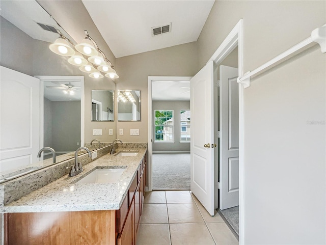 bathroom with ceiling fan, lofted ceiling, tile patterned floors, and vanity