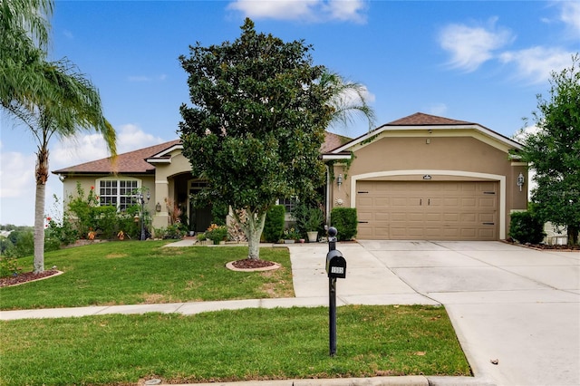 view of front of home with a front yard and a garage