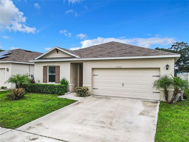 single story home featuring a garage and a front lawn