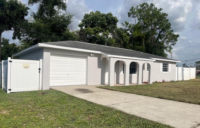 ranch-style home featuring a garage and a front yard