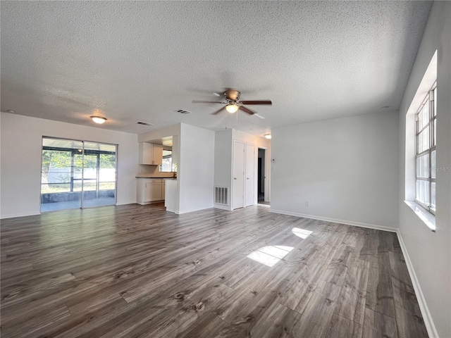 unfurnished living room featuring a textured ceiling, ceiling fan, and hardwood / wood-style floors