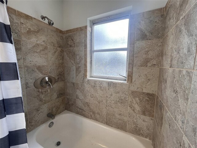 bathroom with shower / bath combo with shower curtain