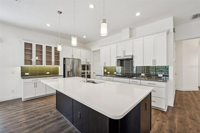 kitchen featuring decorative backsplash, dark hardwood / wood-style floors, stainless steel appliances, and a large island