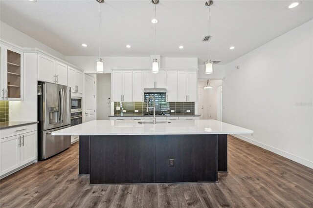 kitchen featuring backsplash, stainless steel appliances, dark hardwood / wood-style flooring, and white cabinetry