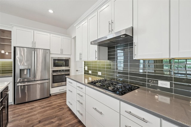 kitchen featuring dark hardwood / wood-style floors, stainless steel appliances, white cabinets, and backsplash