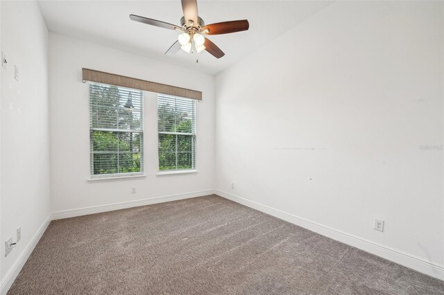 spare room with ceiling fan, carpet flooring, and lofted ceiling