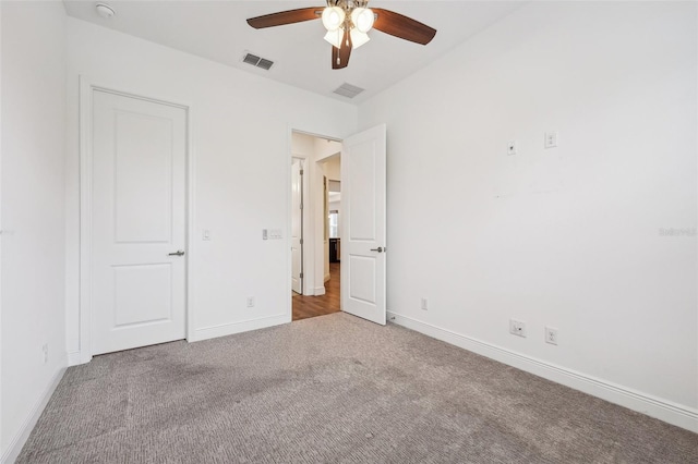 unfurnished bedroom featuring ceiling fan and carpet