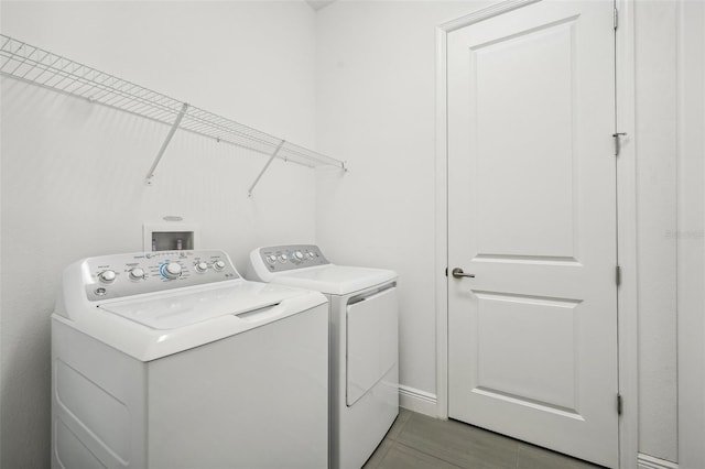 laundry room with tile patterned floors and independent washer and dryer