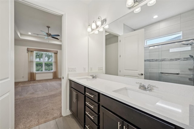 bathroom featuring ceiling fan, tile patterned floors, double vanity, and an enclosed shower