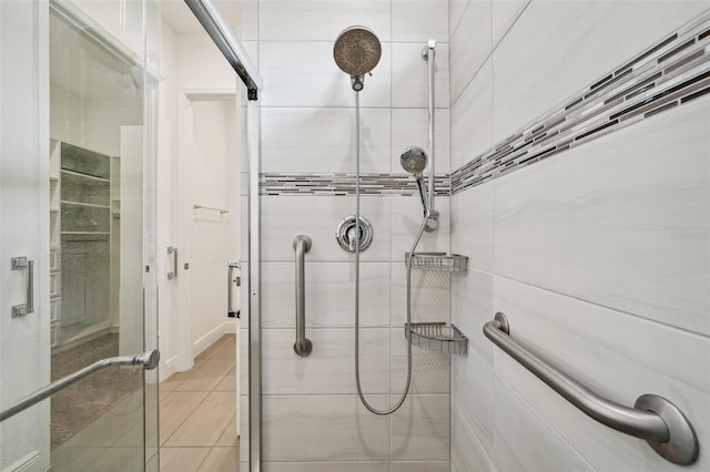 bathroom featuring tile patterned floors and a shower with door