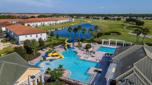 view of swimming pool featuring a pergola, a patio area, a water slide, and a water view