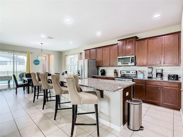 kitchen featuring plenty of natural light, a kitchen island, and stainless steel appliances