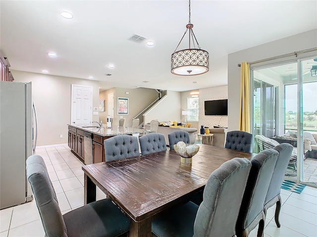 dining space with light tile patterned flooring and sink