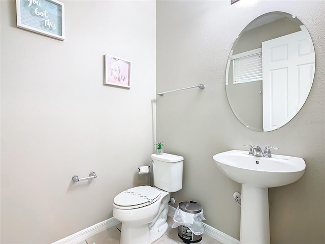 bathroom featuring tile patterned flooring and toilet