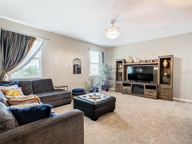 living room with carpet flooring and a notable chandelier