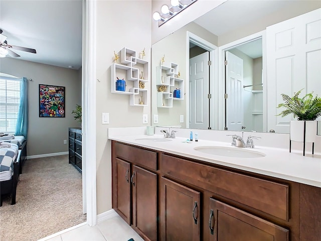 bathroom with dual vanity, tile patterned floors, and ceiling fan